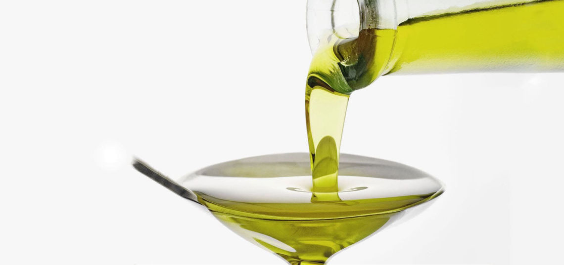 Pure Extra Virgin Olive Oil Pouring into a spoon